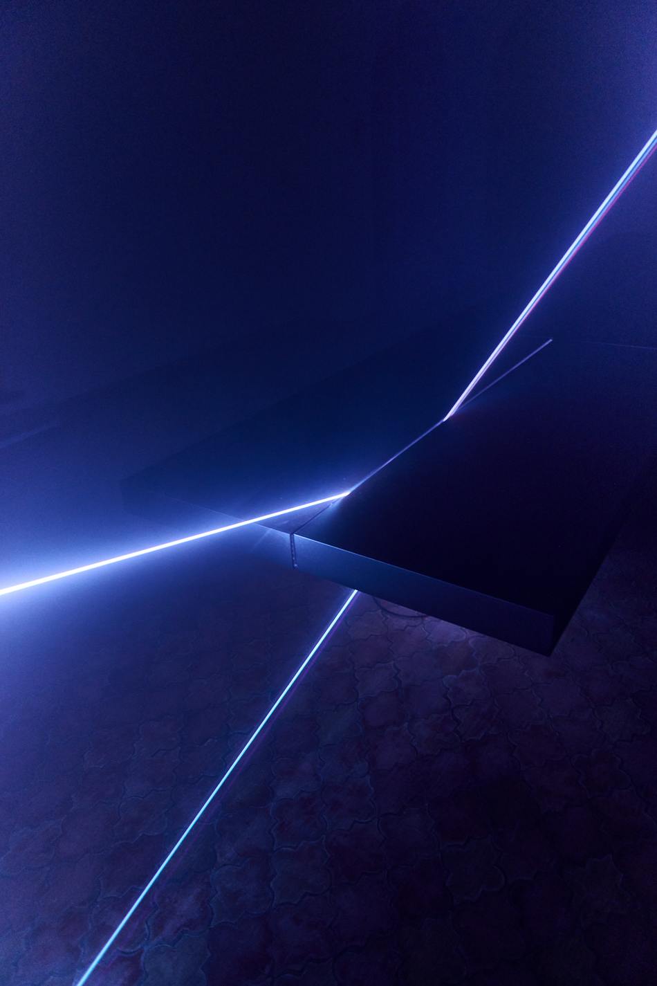 Detail of the illuminated edge of the acrylic Tabula Rasa table cutting through the darkness
