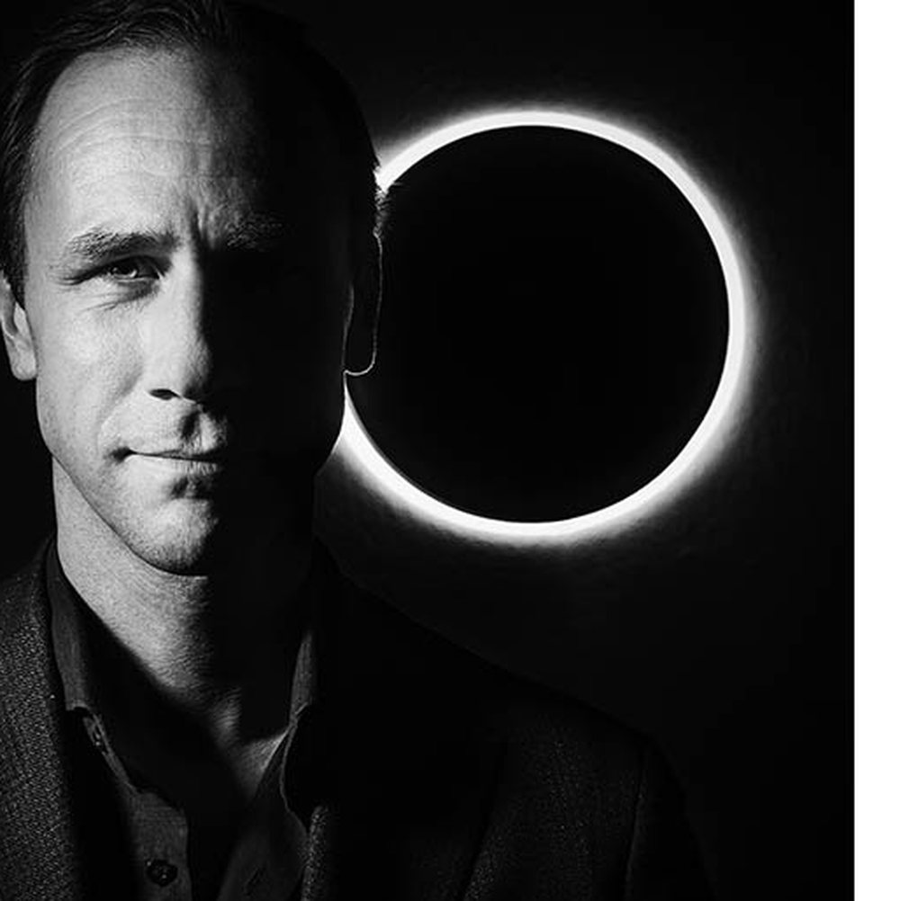 A fragment of a guest portrait taken at the reception, against a ring of light